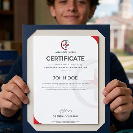 A student holding the framed surgeon-signed Apprentice Doctor certificate